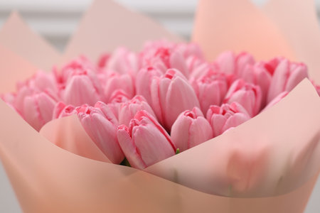 Bouquet of beautiful pink tulips near white wall, closeupの写真素材