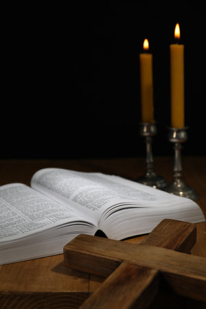 Bible, cross and church candles on wooden tableの写真素材
