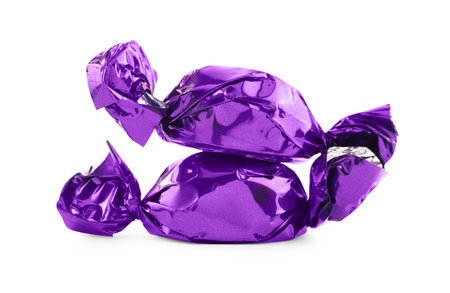 Candies in purple wrappers isolated on whiteの写真素材
