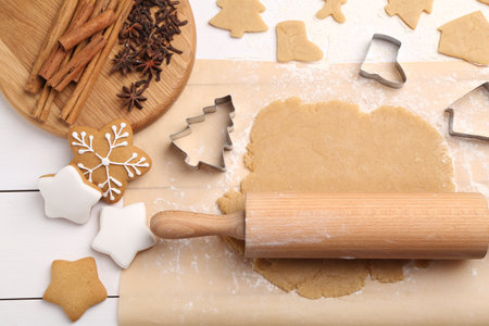Making Christmas cookies. Flat lay composition with ingredients and raw dough on white wooden tableの写真素材