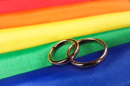 Wedding rings on rainbow LGBT flag, closeupの写真素材