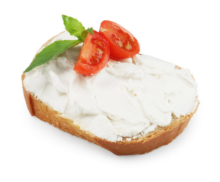 Bread with cream cheese, tomato and basil leaves isolated on whiteの写真素材
