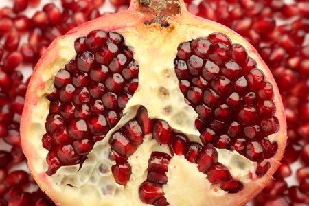 Ripe juicy red pomegranate on grains grains, top viewの写真素材