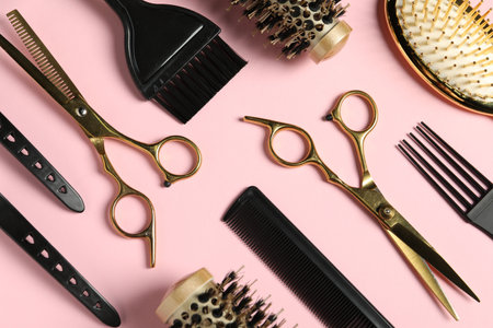 Professional hair dresser tools on pink background, flat layの写真素材