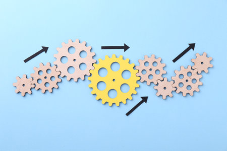Business process organization and optimization. Scheme with wooden figures and arrows on light blue background, top viewの写真素材
