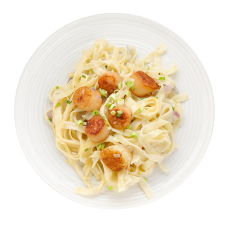 Delicious scallop pasta with onion isolated on white, top viewの写真素材