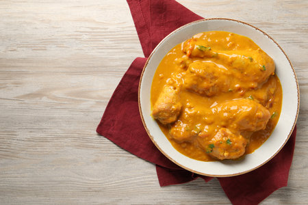 Tasty chicken curry on wooden table, top view. Space for textの写真素材