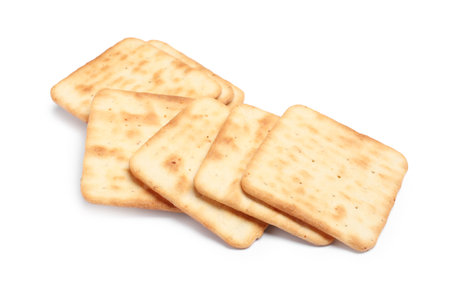 Tasty crispy square crackers isolated on whiteの写真素材