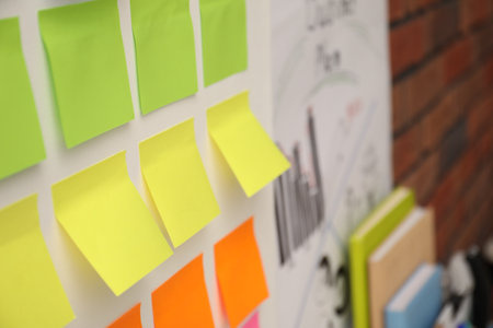 Blank colorful paper notes on white board, closeupの写真素材