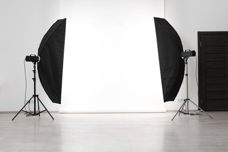 White photo background and professional lighting equipment in studioの写真素材