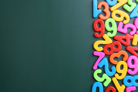 Colorful numbers on green background, flat lay. Space for textの写真素材