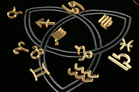 Golden zodiac signs on dark background, closeupの写真素材
