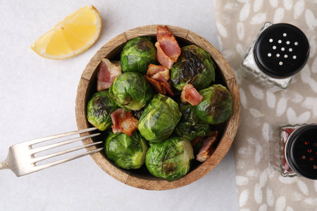 Delicious roasted Brussels sprouts and bacon served on light table, top viewの写真素材