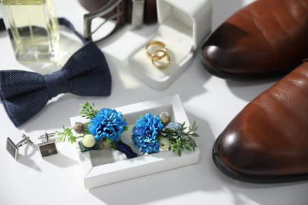 Wedding stuff. Composition with stylish boutonniere on white background, closeupの写真素材