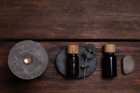 Flat lay composition with spa products and eucalyptus branch on wooden table. Space for textの写真素材