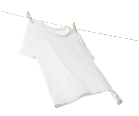 One t-shirt drying on washing line isolated on white, low angle viewの写真素材