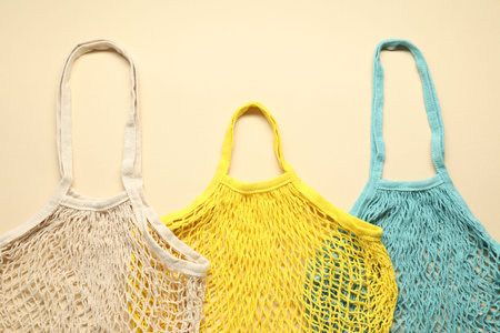 String bags on beige background, top viewの写真素材