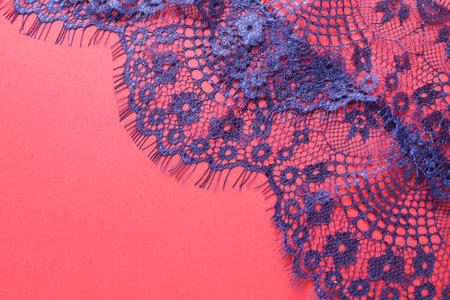 Blue lace on red background, top view. Space for textの写真素材