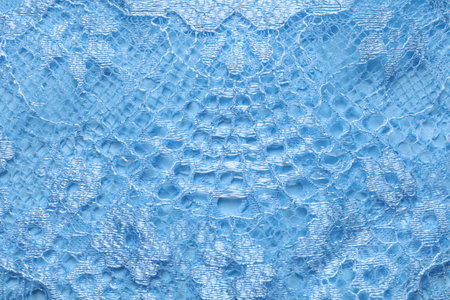 Light blue lace as background, top view
