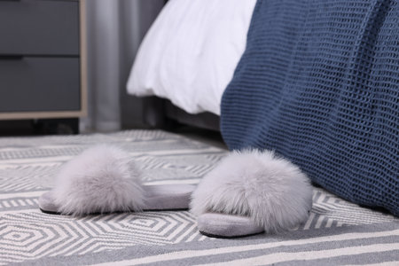 Gray soft slippers on carpet indoors, closeupの写真素材