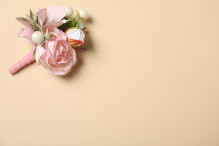 Stylish pink boutonniere on beige background, top view. Space for textの写真素材