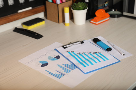 Business process planning and optimization. Workplace with different graphs and other stationery on...