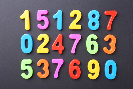 Colorful numbers on dark gray background, flat layの写真素材