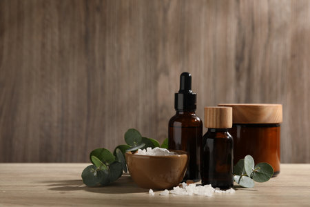 Composition with spa products and eucalyptus leaves on wooden tableの写真素材