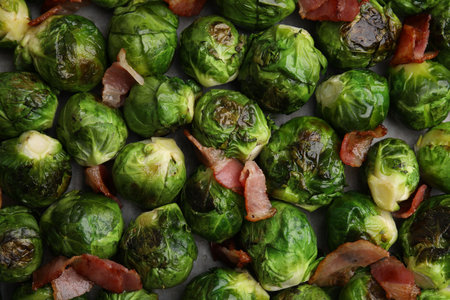 Delicious roasted Brussels sprouts and bacon as background, top viewの写真素材