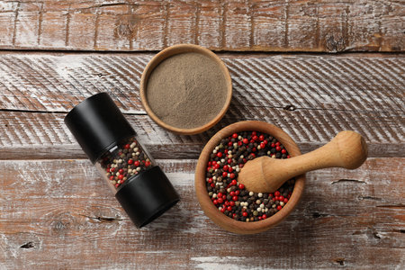 Ground pepper and grains on wooden table, flat layの写真素材