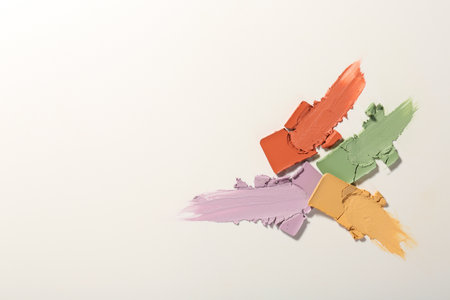 Samples of different color correcting concealers on white background, top viewの写真素材