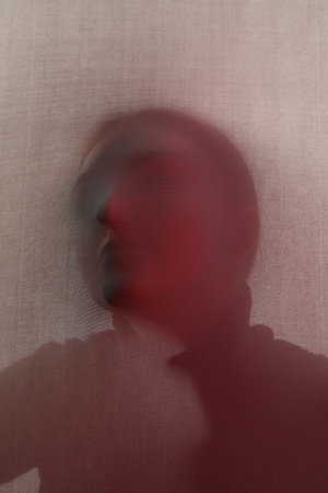 Silhouette of creepy ghost behind cloth, color tonedの写真素材