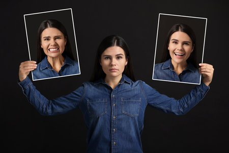 Woman holding her photo portraits showing different emotions on black background. Balanced personalityの写真素材