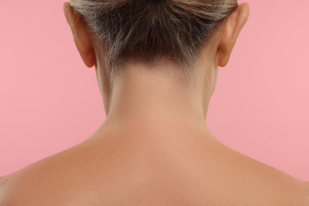 Mature woman with healthy skin on pink background, closeupの写真素材
