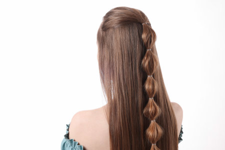 Woman with braided hair on white background, back view