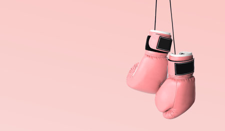 Fight against breast cancer. Pair of pink boxing gloves on color background, space for text. Banner designの写真素材