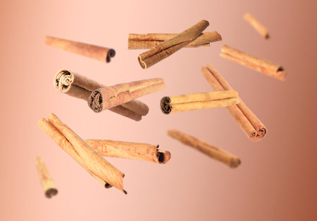 Aromatic dry cinnamon sticks on brown backgroundの写真素材