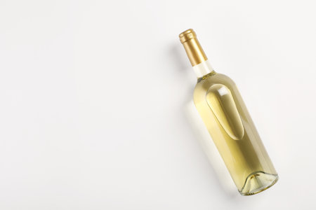 Bottle of expensive white wine on light background, top view. Space for textの写真素材