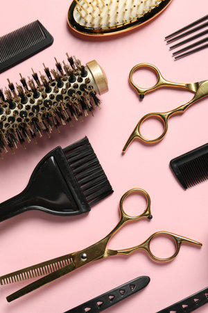 Professional hair dresser tools on pink background, flat layの写真素材