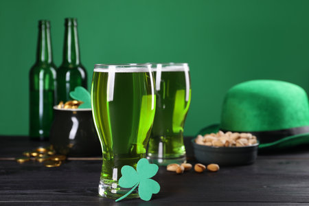 St. Patrick's day party. Green beer, leprechaun hat, pot of gold, pistachios and decorative clover...
