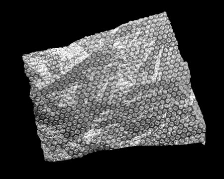 Transparent pooping wrap on black background, top view