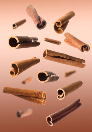 Aromatic dry cinnamon sticks on brown background