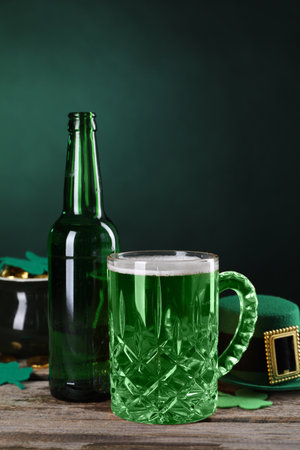 St. Patrick's day party. Green beer, leprechaun hat, pot of gold and decorative clover leaves on wooden tableの写真素材