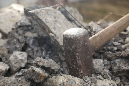 Sledgehammer on pile of broken stones outdoors, closeupの写真素材