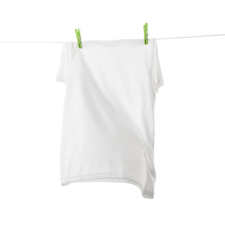 One t-shirt drying on washing line isolated on white