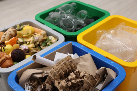 Garbage sorting. Full trash bins for separate waste collection indoors, closeup
