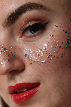 Beautiful woman with glitter freckles, closeup viewの写真素材