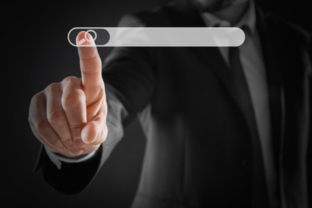 Man pointing at search bar on virtual screen against dark background, closeupの写真素材