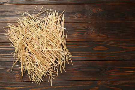 Dried hay on wooden background, top view. Space for textの写真素材