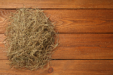 Dried hay on wooden background, top view. Space for textの写真素材